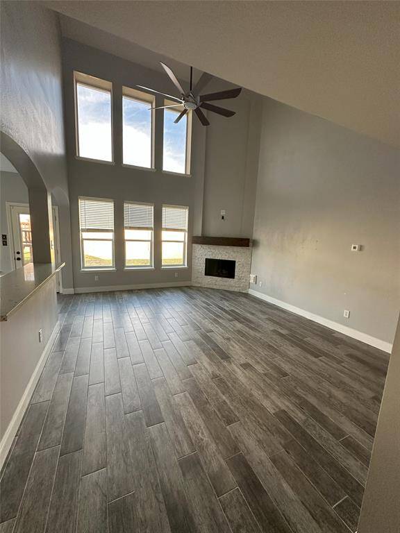 Large Den with gas started fire place, wonderful 2 story windows bring in lots of light
