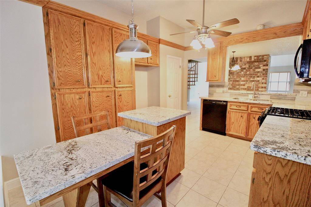 View of the breakfast area and kitchen featuring beautiful granite countertops. This kitchen offers lots of counter and cabinet space.