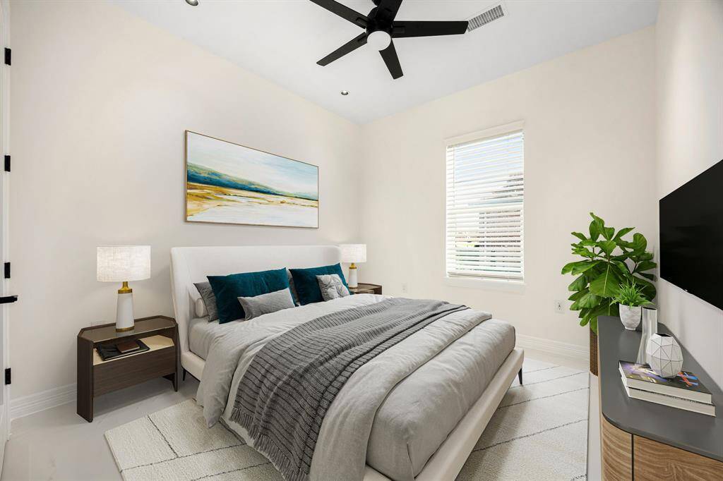 This cozy secondary bedroom offers a tranquil atmosphere with soft neutral tones, abundant natural light, and modern design touches. Highlights include sleek tile flooring, a stylish ceiling fan, and ample space for comfort and functionality—ideal for guests, a home office, or a peaceful retreat.