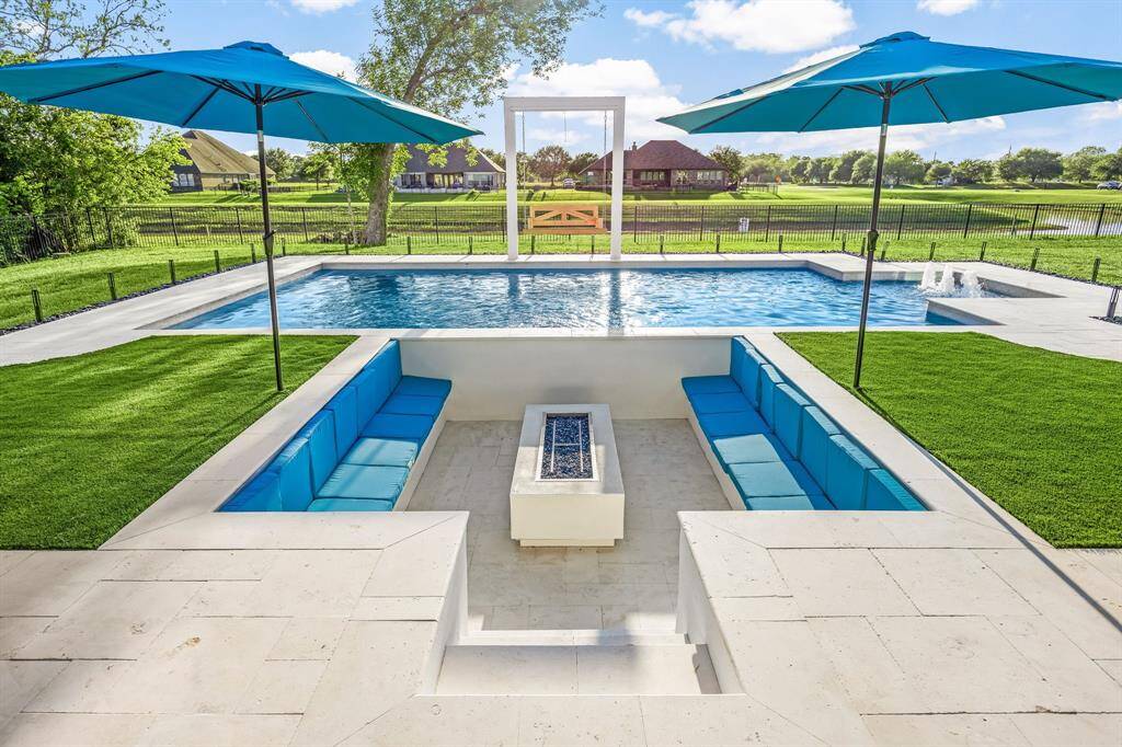 Experience resort-style living in this stunning waterfront oasis, featuring a sparkling pool, sunken firepit lounge, and panoramic views. Perfectly designed for entertaining or relaxing under the sun, this backyard retreat blends luxury and tranquility in every detail.