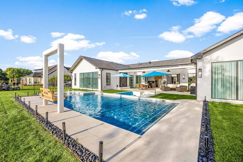 Welcome to your private backyard paradise! This modern outdoor haven showcases a resort-style pool, custom swing, multiple lounging areas, and seamless indoor-outdoor flow—perfect for entertaining or unwinding in style.