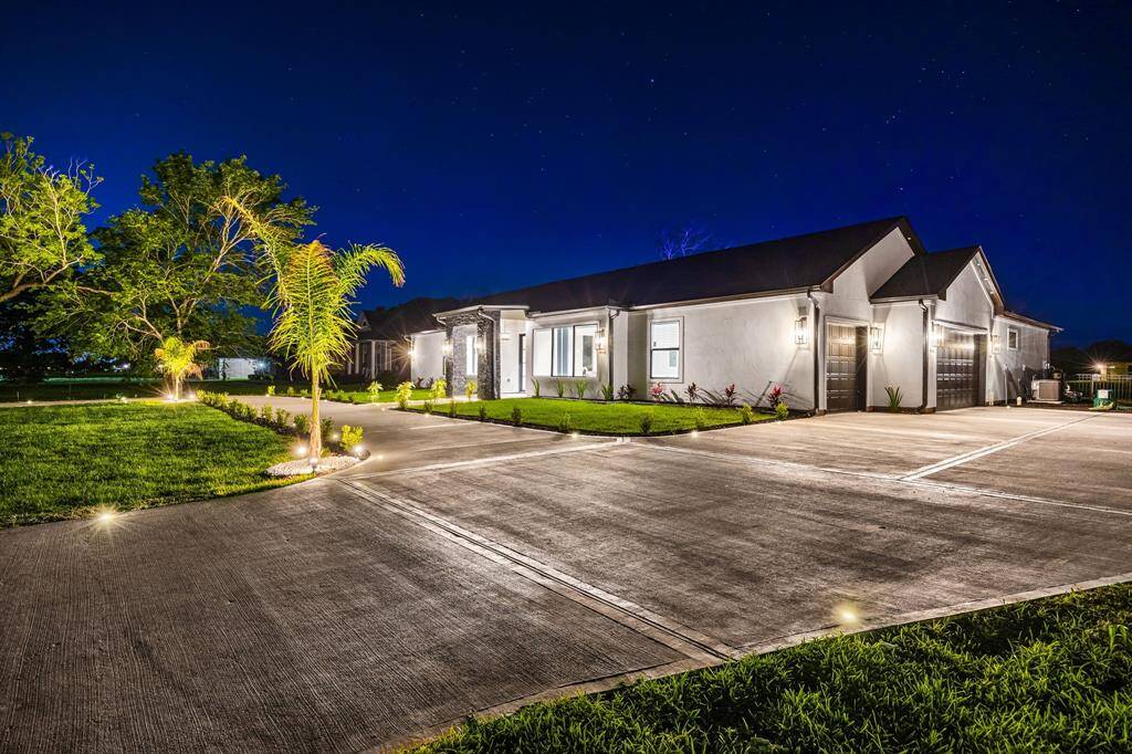 This newly built custom home boasts striking curb appeal with dramatic nighttime lighting, a wide driveway, and a 3-car garage. The sleek architecture and manicured landscaping make a bold first impression, while inside you'll find luxurious finishes and open-concept living designed for comfort and style. This is upscale living redefined—where sophistication and serenity come home.