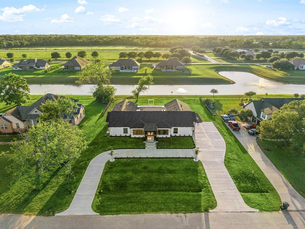 This elegant home is perfectly situated on a generous waterfront lot, featuring a long, private driveway and beautifully maintained landscaping. With serene water views and a peaceful neighborhood setting, this property offers both privacy and picturesque surroundings—ideal for relaxing and entertaining.