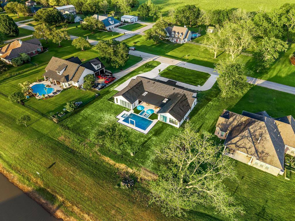 This stunning waterfront property features a spacious backyard with a sleek in-ground pool and spa, offering the perfect blend of luxury and outdoor living. Situated in a peaceful neighborhood, the home boasts a generous lot with beautifully maintained landscaping and a private setting ideal for entertaining or relaxing.