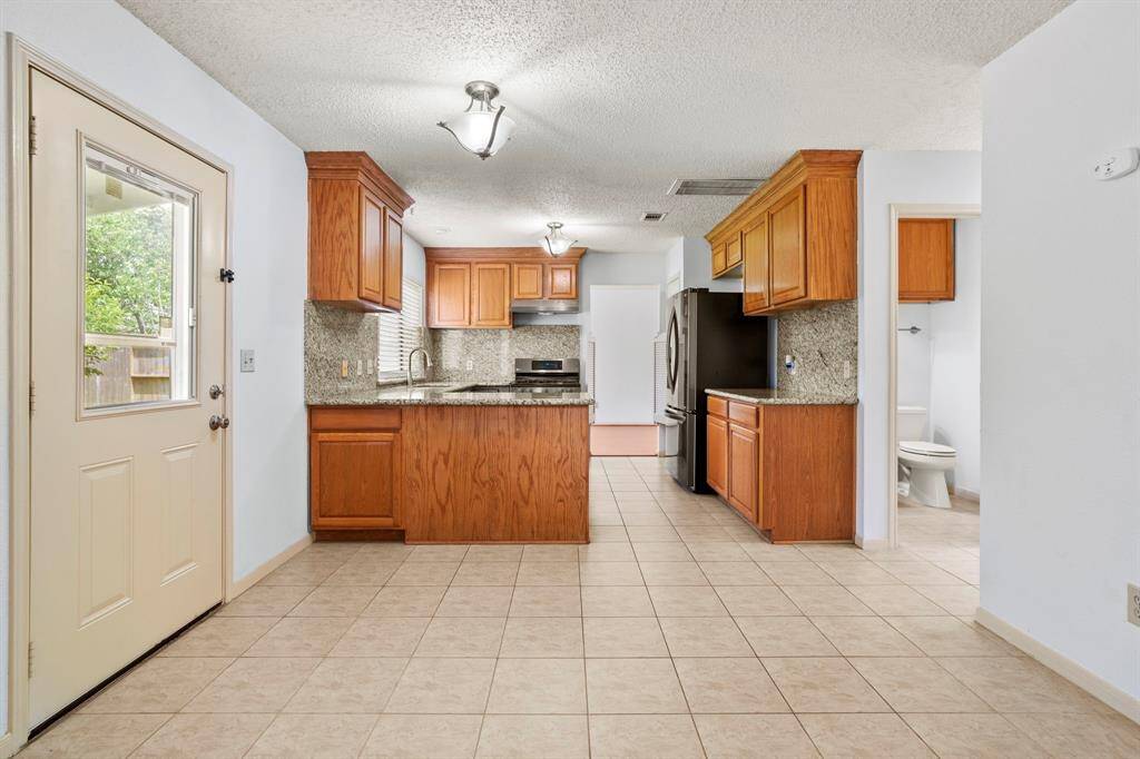 The kitchen and family room offer quick access to the covered patio and fully fenced backyard.