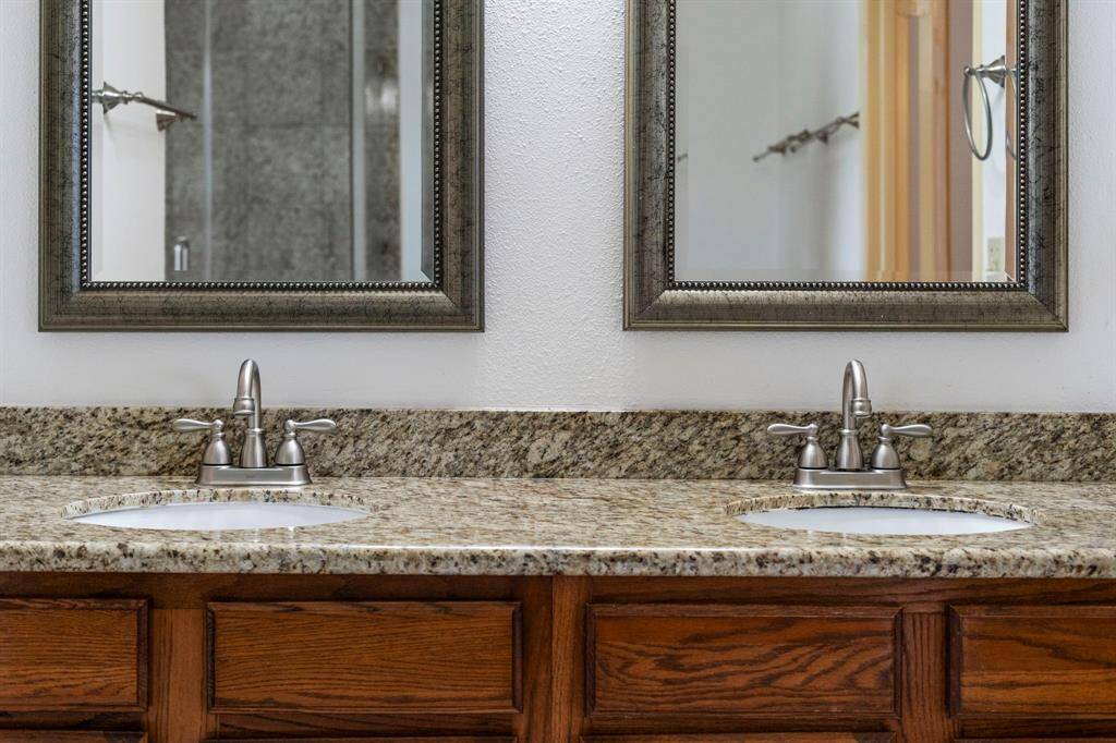 A dual granite vanity provides ample space and a touch of luxury.