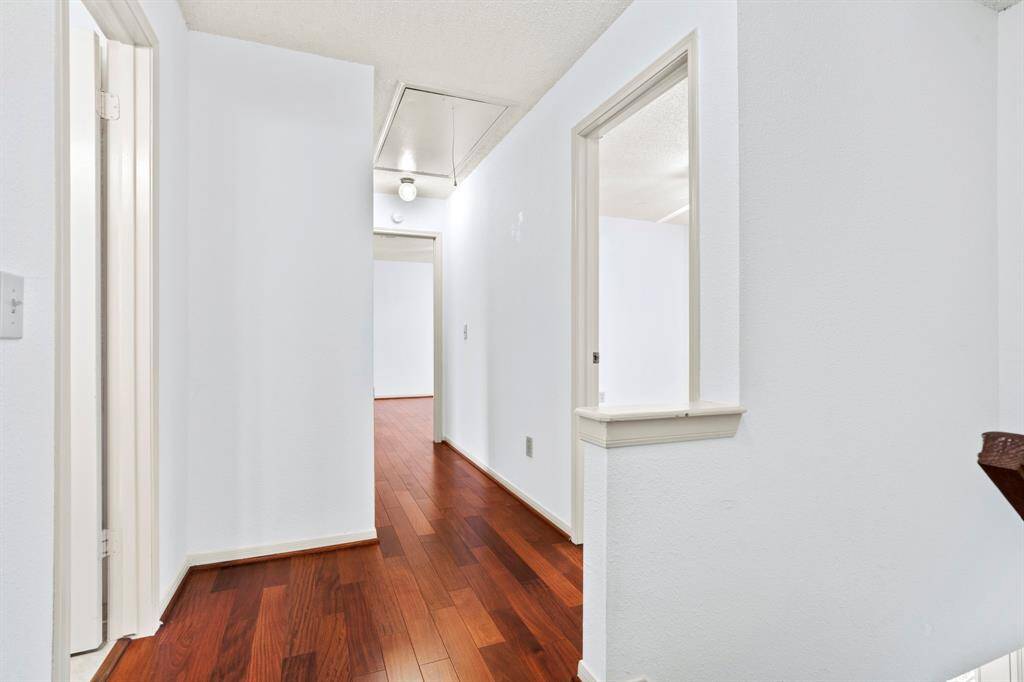 An upstairs hallway connects the bedrooms, offering a functional and cohesive layout.