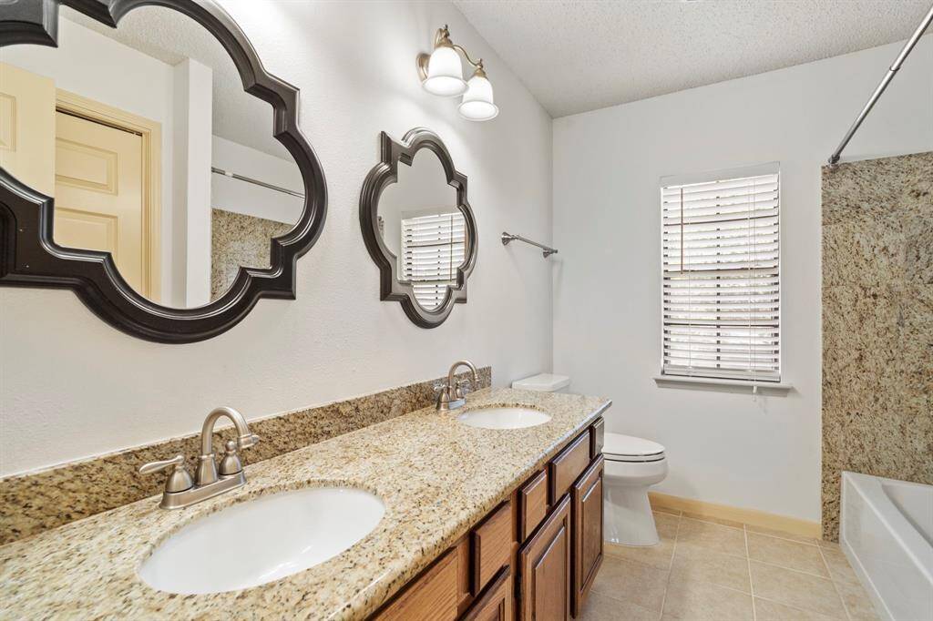 The full bathroom offers a granite dual vanity, a convenient shower/tub combination, and a built-in linen closet for added storage.