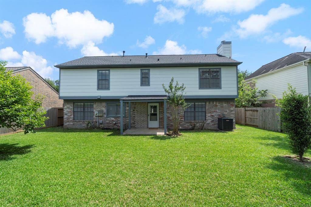 Enjoy a fully fenced backyard with plenty of green grass for outdoor activities.