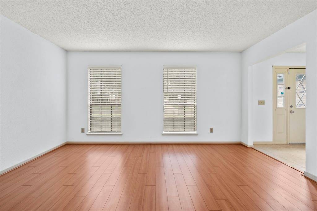 Large windows fill the living room and dining room with natural light.