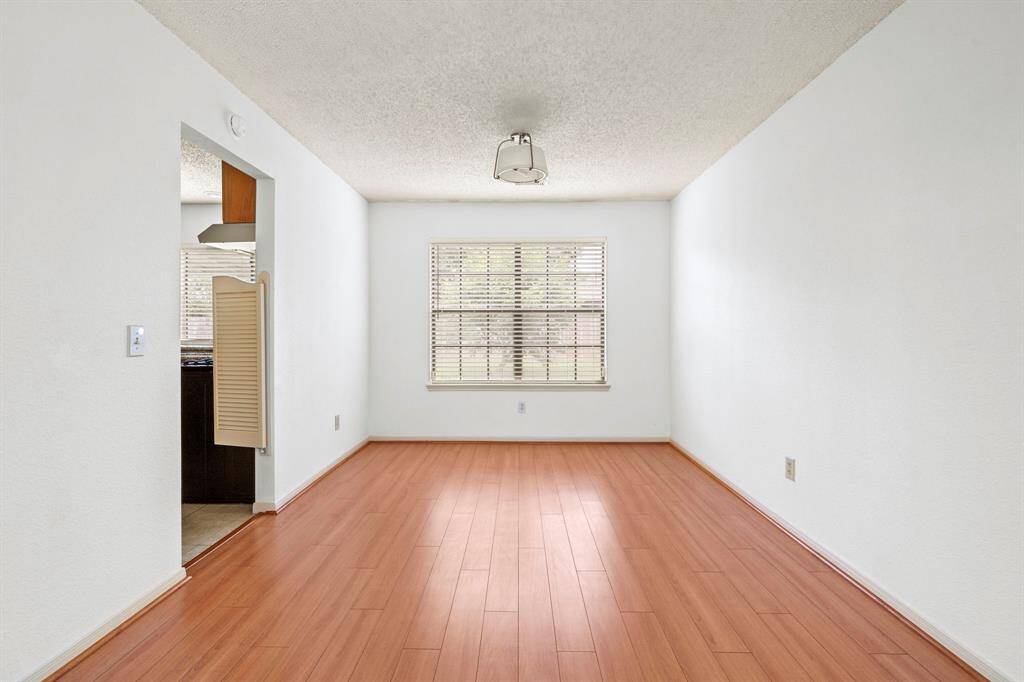The dining room, ideally located next to the kitchen, showcases a stylish new light fixture.