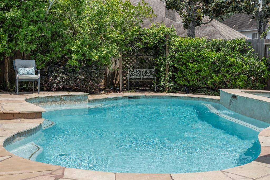Enjoy outdoor living year-round in the sparkling heated pool and spa, enhanced by a tranquil waterfall and lush, low-maintenance landscaping.
