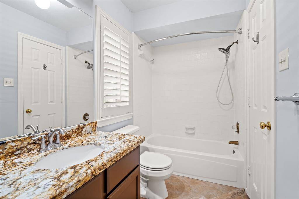 This full bathroom is conveniently accessible from both the game room and one of the second-floor bedrooms, offering easy access for guests and residents.