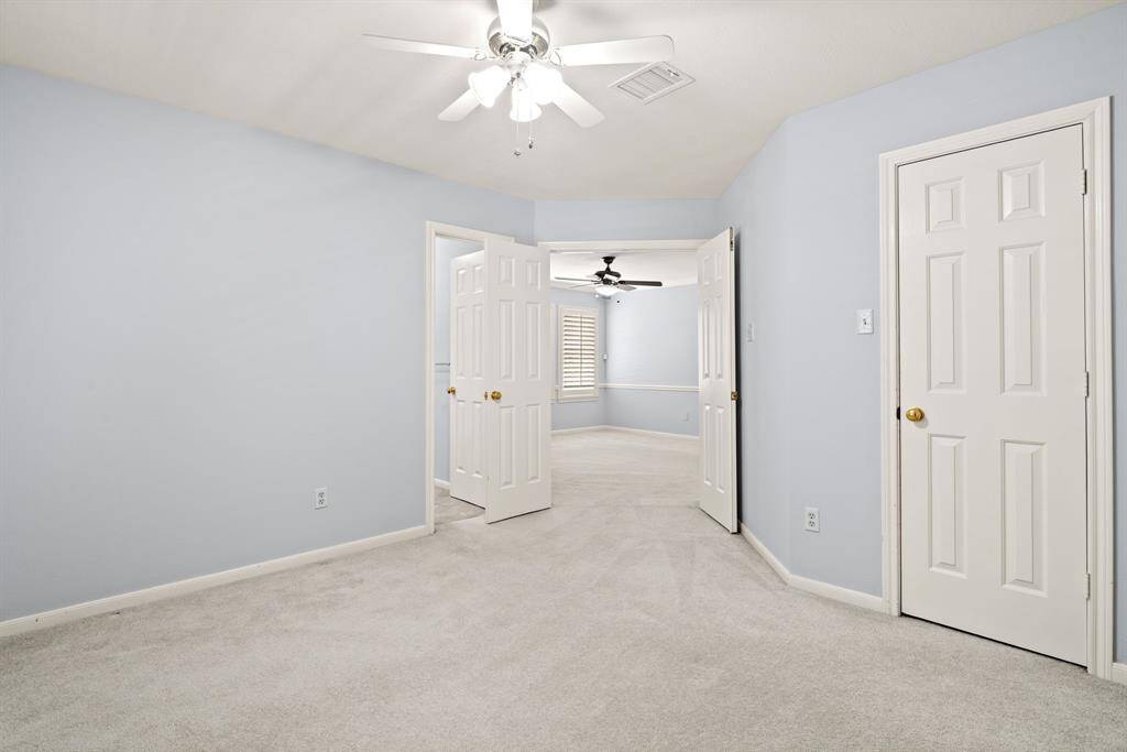 The spacious bedroom adjacent to the game room is ideal for a guest or in-law suite, complete with an en suite bathroom for added privacy and comfort. The game room itself could easily serve as a private living area, providing guests with a separate, relaxed space to unwind.