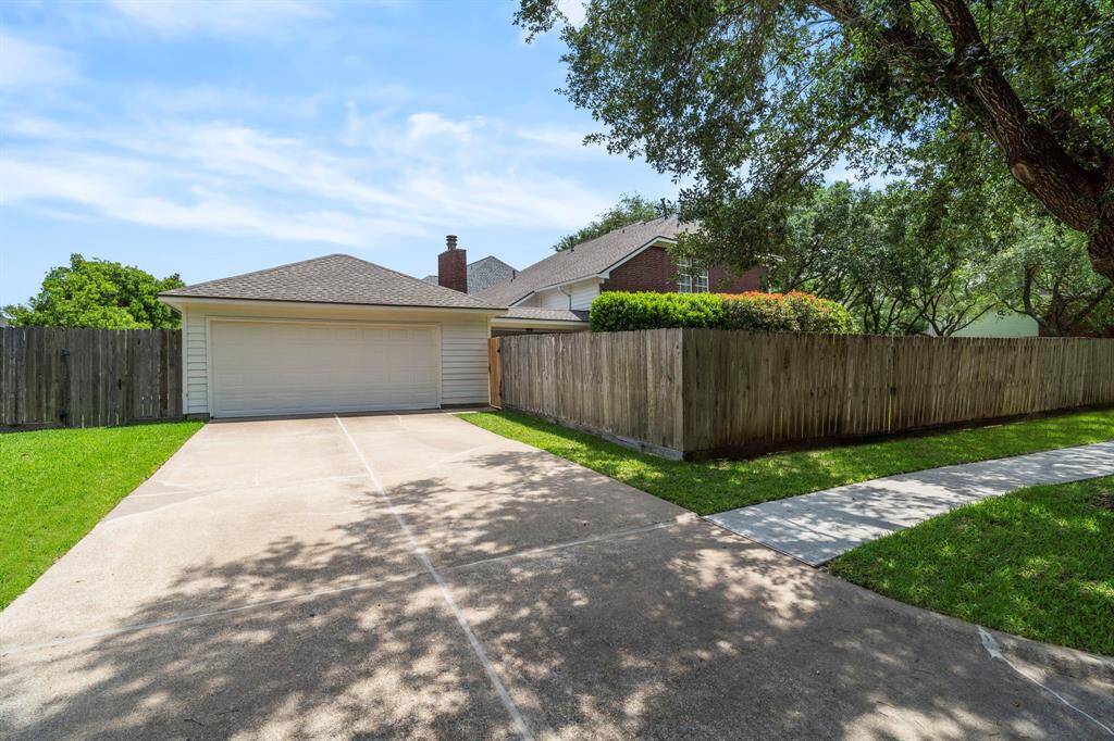 A double wide driveway leads to a detached 2-car garage, providing ample off-street parking for both family and guests.