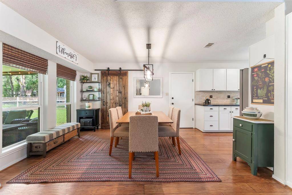 Tucked away behind the barn door is a pantry and stackable washer/dryer.