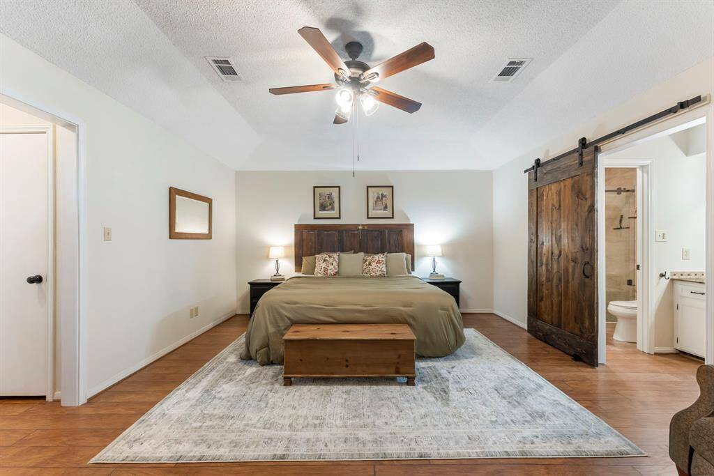 In this split floor plan, the oversized primary bedroom suite is positioned at the rear of the home.