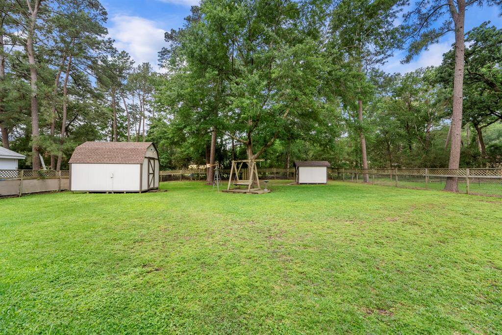 The backyard houses a workshop and a storage shed.
