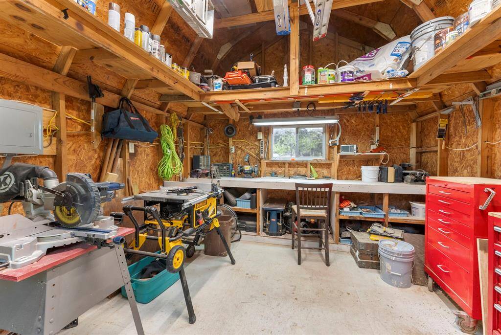 The workshop has overhead storage in addition to workspace.