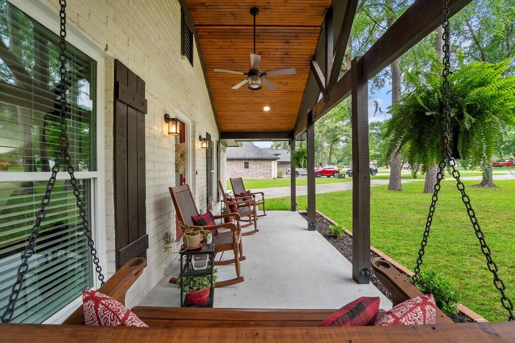 No detail left behind on the front porch. Tongue and groove ceiling with recessed lights and a ceiling fan.