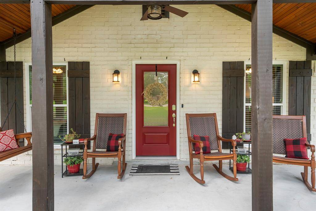 The red front door symbolizes a welcoming and hospitable home.