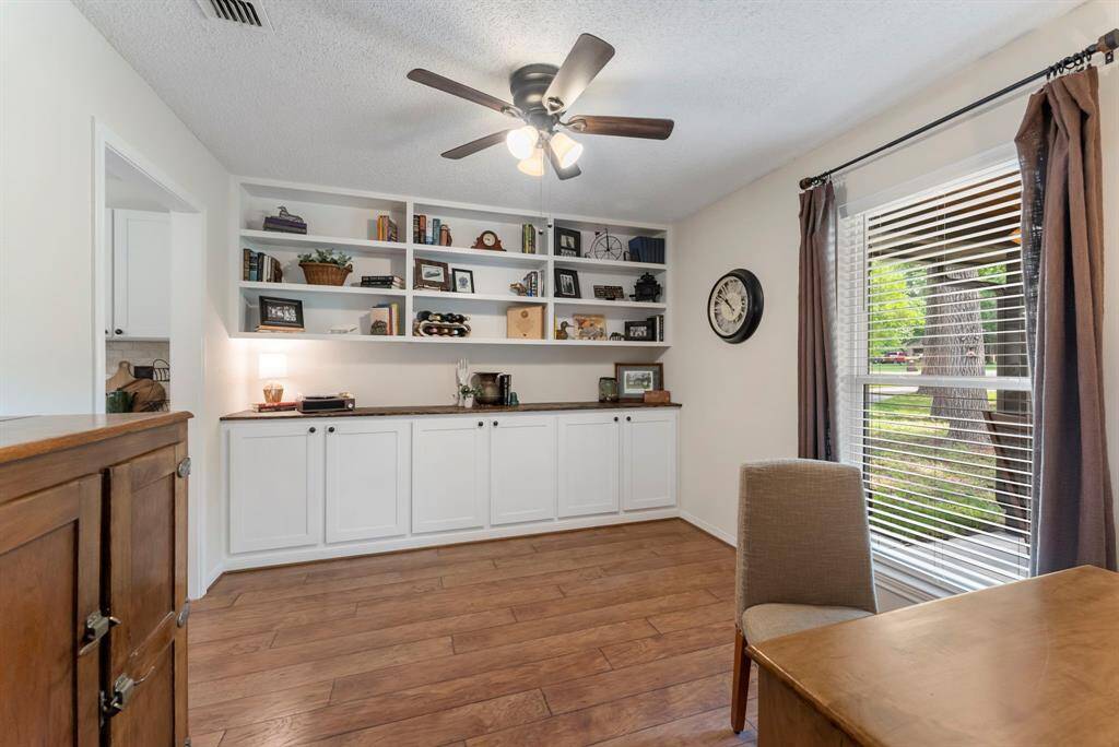 As you enter the front door, to the right is the home office with custom built-in shelving and storage.