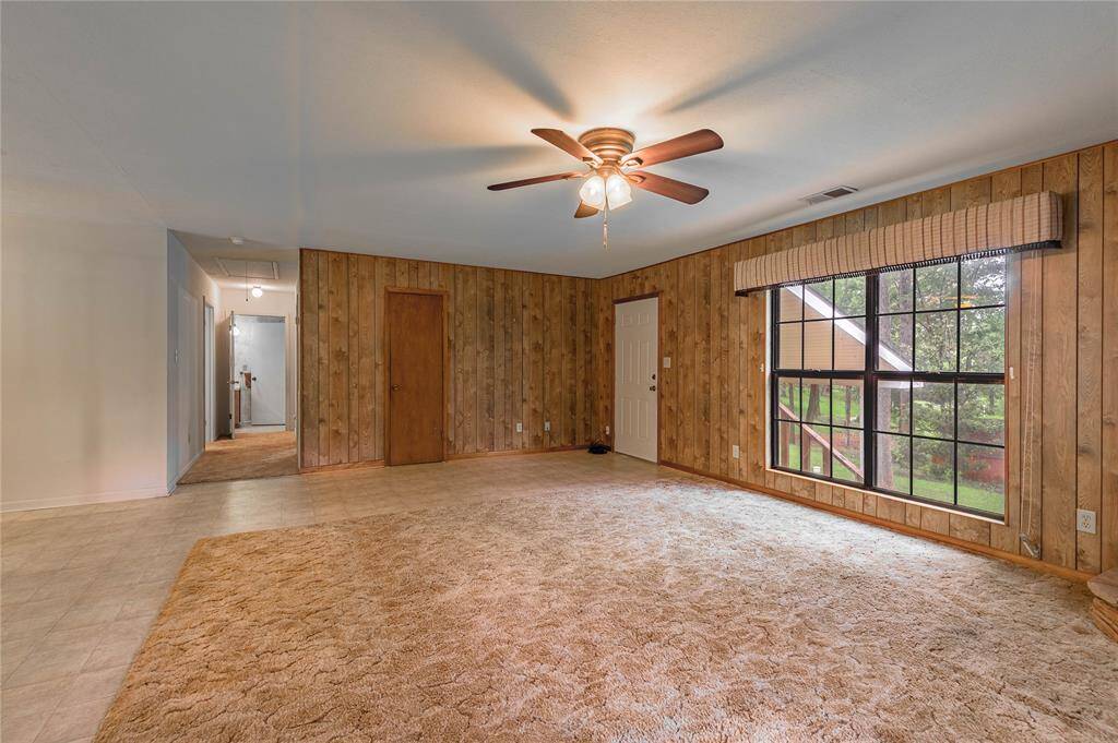 Living room with large window overlooking the back yard