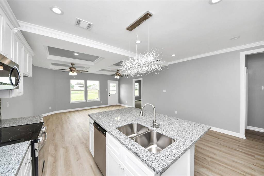 This thoughtfully designed kitchen opens seamlessly into the family room, creating a connected and functional space that’s perfect for entertaining. Whether you're cooking dinner or hosting guests, the open layout allows you to stay engaged with family and friends.
