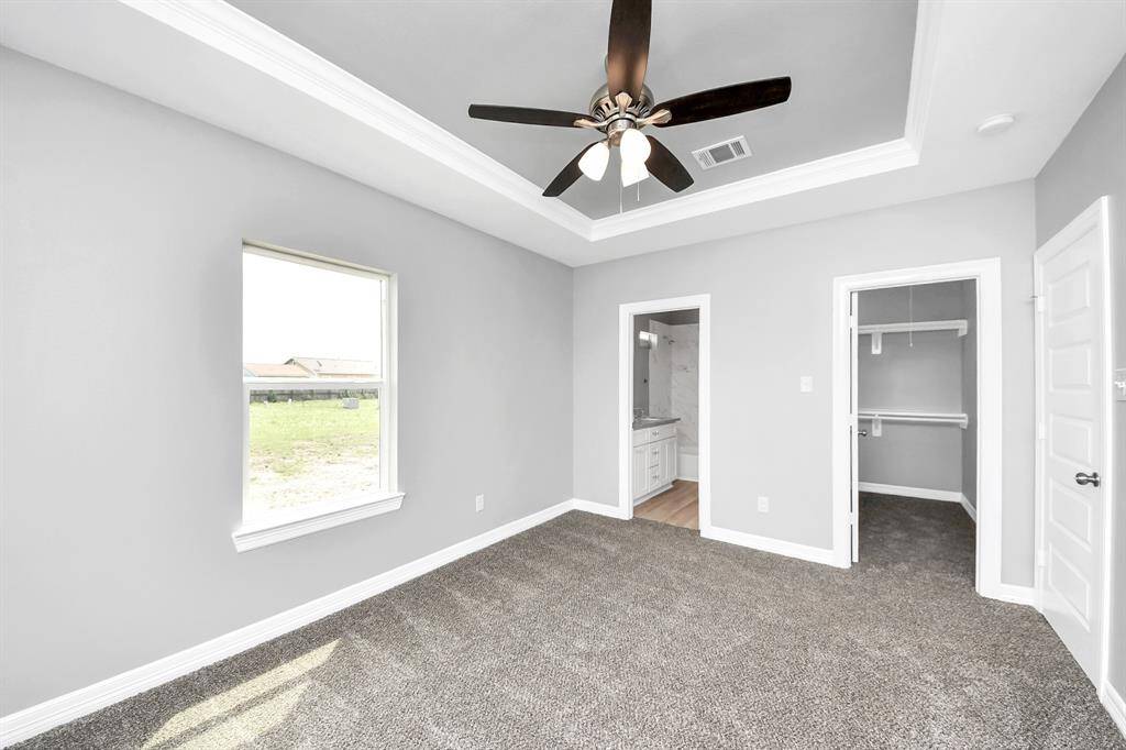 Here's another view of the gorgeous primary suite, a true sanctuary featuring a spacious walk-in closet with plenty of storage for all your wardrobe essentials. The attached ensuite bathroom is designed with both style and convenience in mind to meet your everyday needs.