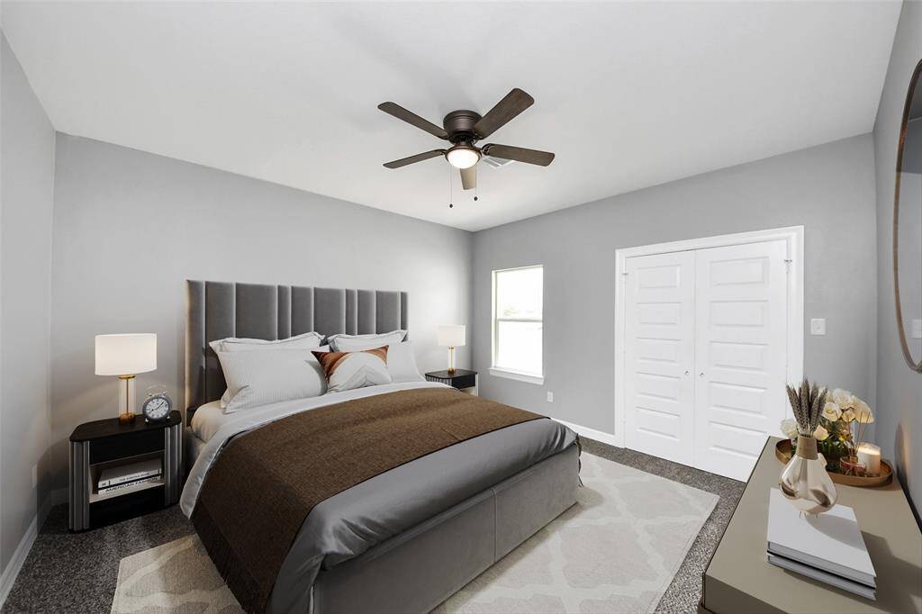 This inviting secondary bedroom features neutral-toned walls for a timeless look, a spacious closet for ample storage, a ceiling fan for added comfort, and plush carpeting - virtually staged.