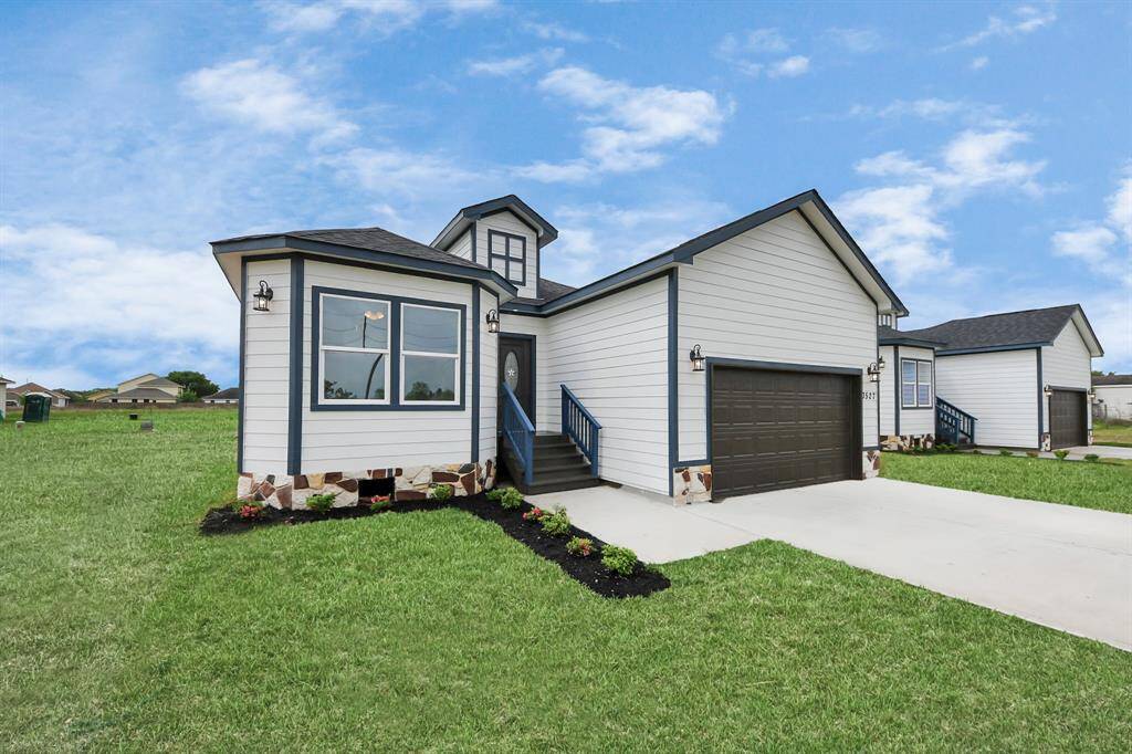 This newly built home features a clean and modern exterior with a striking front elevation that combines subtle architectural details with a neutral color palette. The well-maintained landscaping adds to its curb appeal, with neatly trimmed shrubs and a fresh lawn.