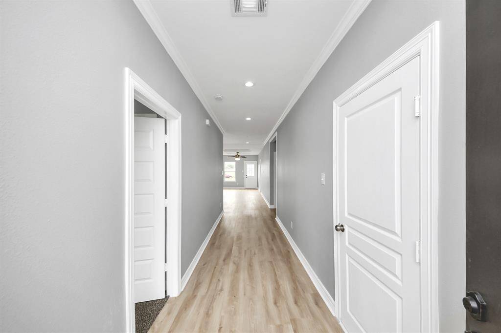 The entryway greets you with a bright, spacious foyer showcasing a neutral color palette, elegant crown molding, and detailed baseboards. Durable luxury laminate flooring flows seamlessly throughout, setting the stage for the home’s modern yet welcoming design.The entryway greets you with a bright, spacious foyer showcasing a neutral color palette, elegant crown molding, and detailed baseboards. Durable luxury laminate flooring flows seamlessly throughout, setting the stage for the home’s modern yet