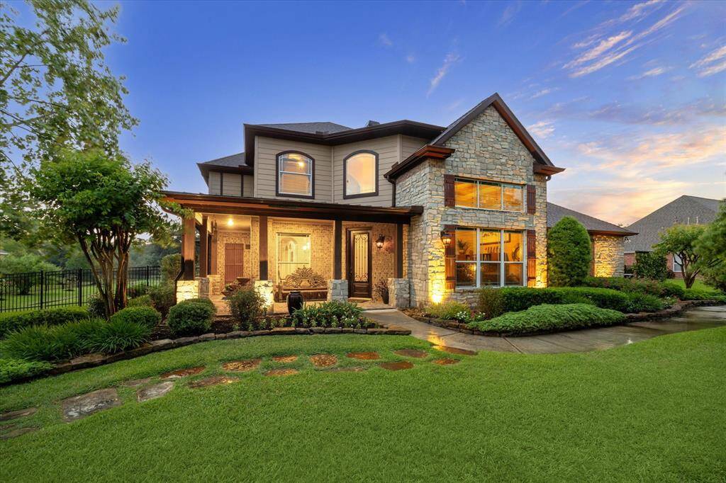 Welcome home to 36927 Anglers Way nestled in the prestigious gated community of Old Mill Lake. This beautifully crafted waterfront two-story residence boasts timeless curb appeal with its stone, siding and brick exterior, expansive windows, and manicured landscaping. A charming covered front porch invites you in, while warm exterior lighting enhances the home’s elegant architecture.