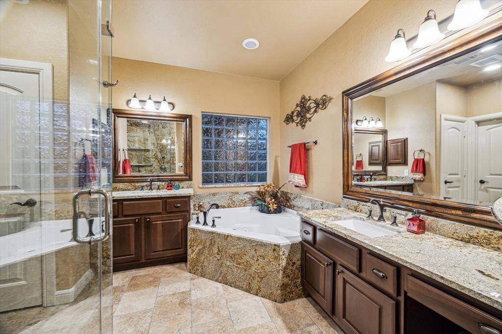 Step into a true spa retreat, where luxury and thoughtful design meet.  Highlights include a Kohler smart toilet/bidet with nickel accents, travertine flooring, dual vanities, and a moisture-control exhaust system—crafted for both relaxation and functionality.