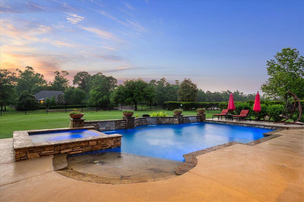 This stunning backyard retreat showcases a custom heated pool with an advanced O2 system and Intellichem automatic chemical feed for easy maintenance. Enjoy the soothing ambiance of cascading waterfalls, a relaxing hot tub, and a built-in tanning deck—all set against sweeping views of the lake and surrounding greenspace. Whether lounging poolside or enjoying a sunset soak, this outdoor oasis offers a perfect blend of luxury, comfort, and natural beauty.
