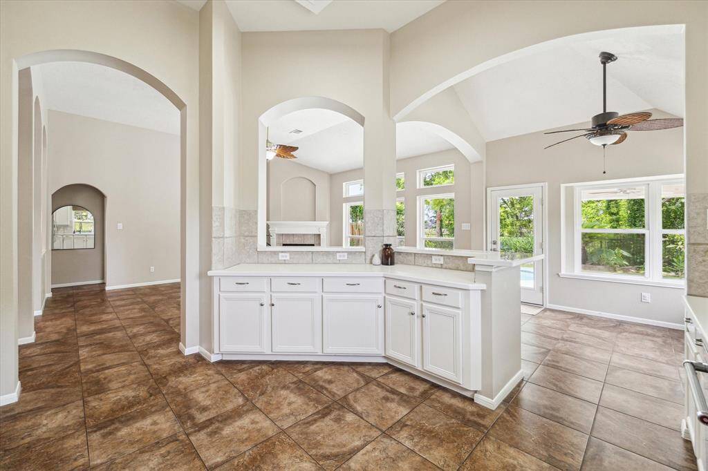 View from the kitchen, looking out with a ceiling fan above the breakfast nook area.