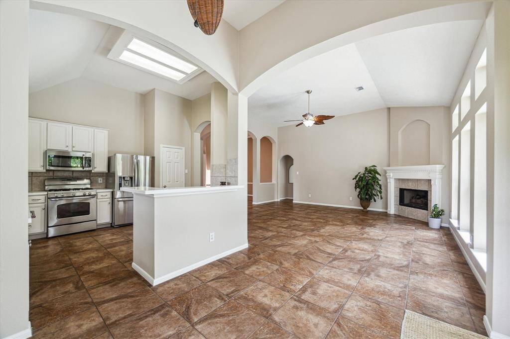 A view from the breakfast nook of the kitchen and living room to show how open the living areas are in this home.