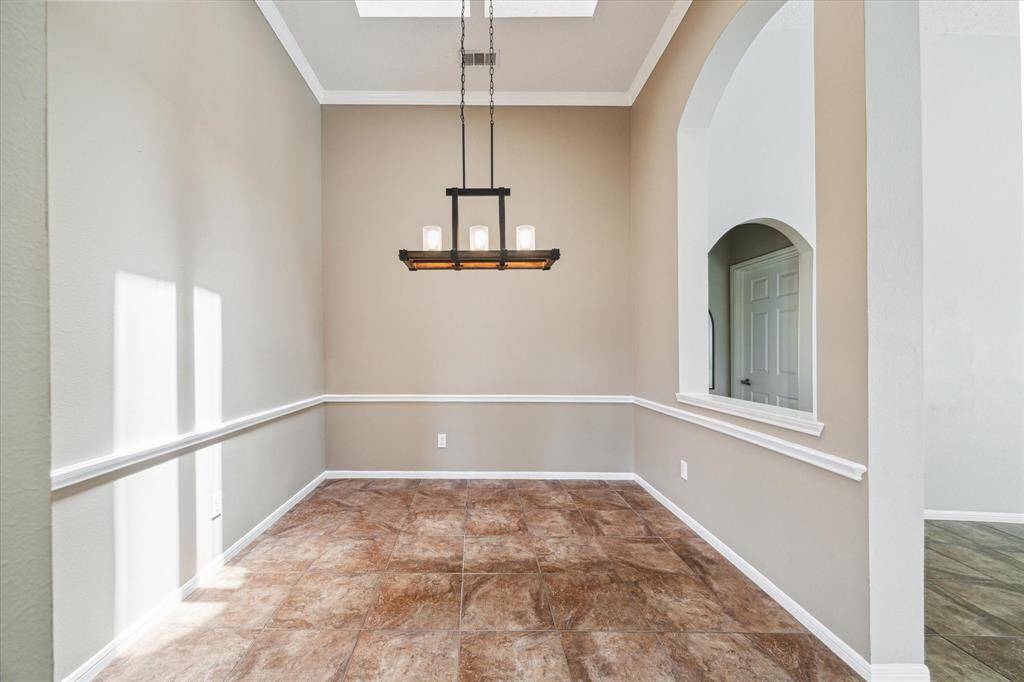 This spacious formal dining room is ideal for entertaining, hosting formal dinners, or enjoying casual meals.