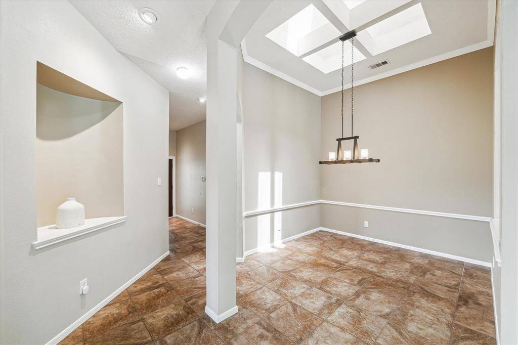 Final view of the dining area off the foyer, featuring charming nooks perfect for artwork and decorative items.