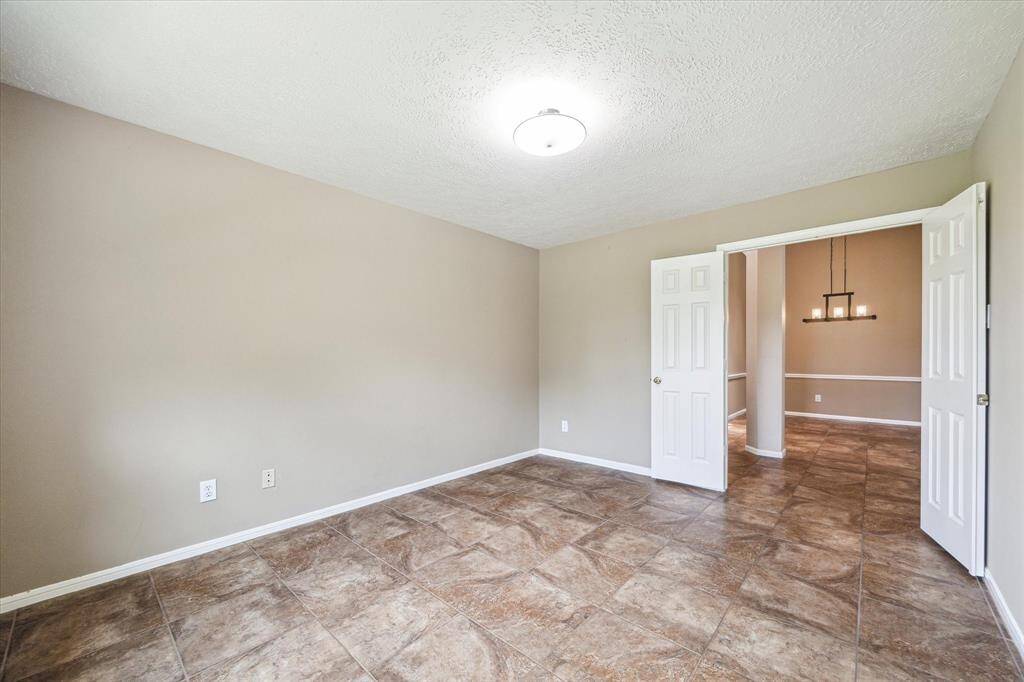 Off the foyer is an additional room with double doors which can be used for an at home office or converted into a fourth bedroom.