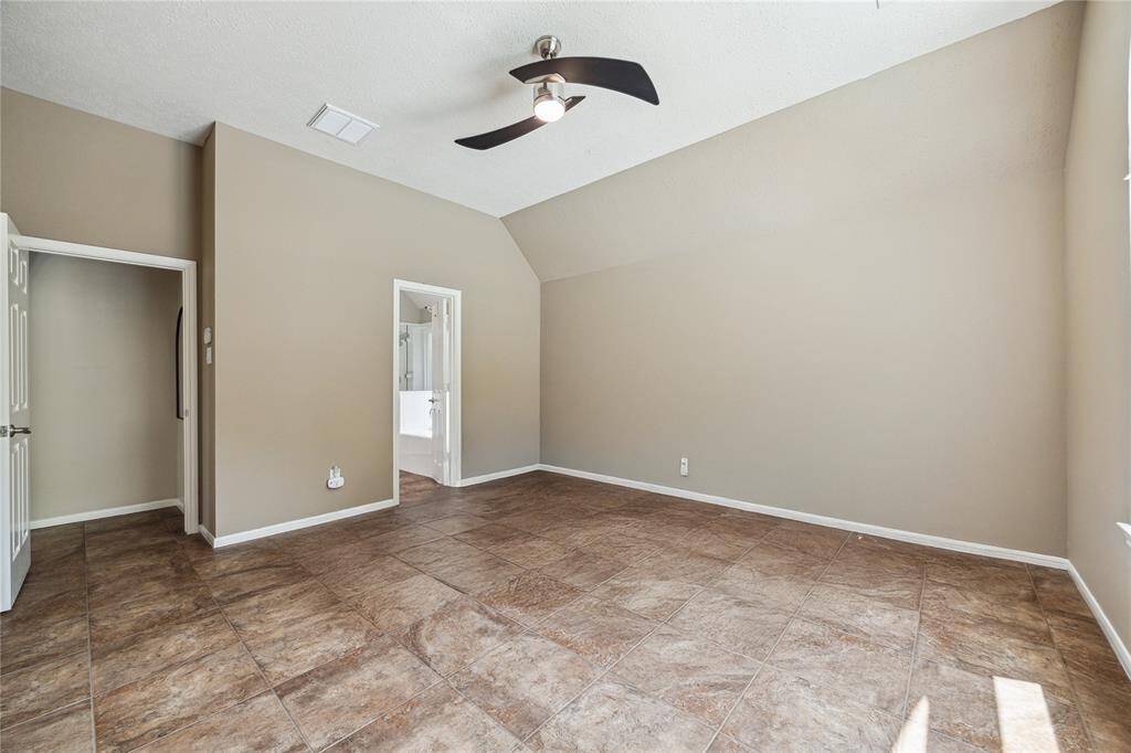 The primary bedroom, complete with an ensuite bathroom, is located at the back of the home for added privacy and tranquility.
