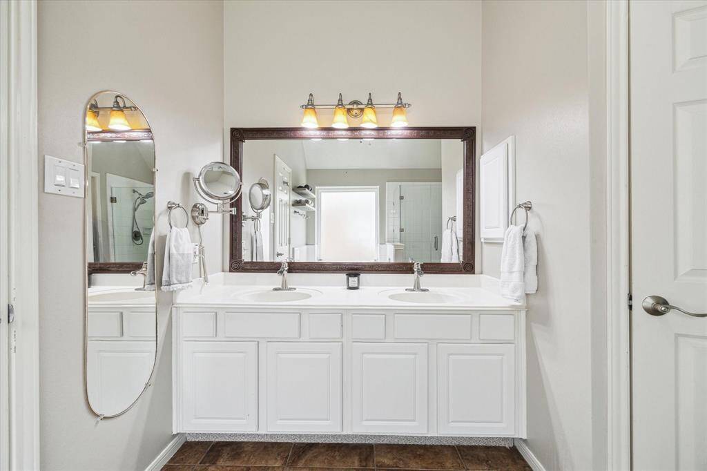 Ample bathroom counter space with dual sinks, creating a light and bright atmosphere.