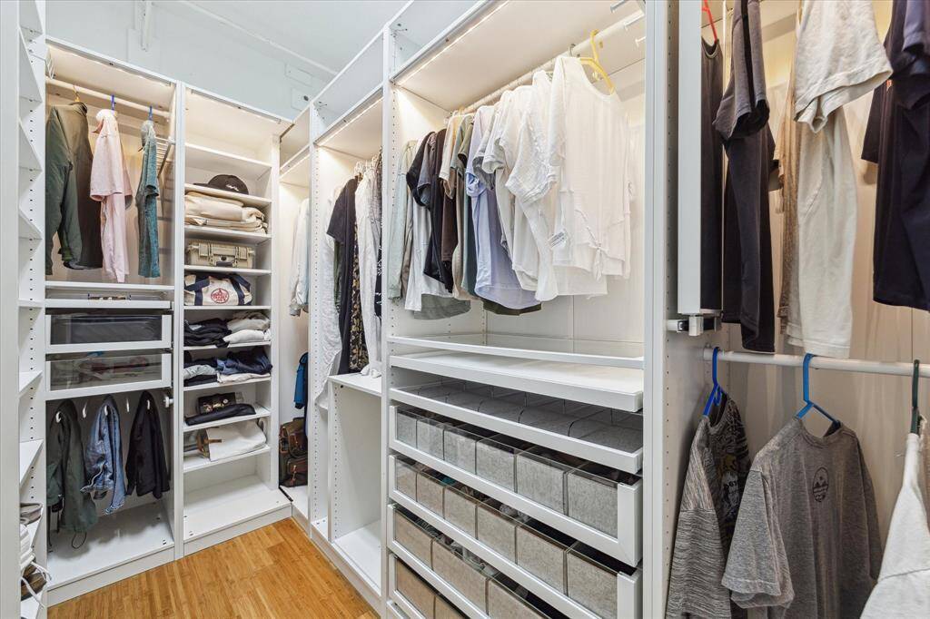 The primary closet boasts stunning custom built-ins, making organization effortless and efficient.
