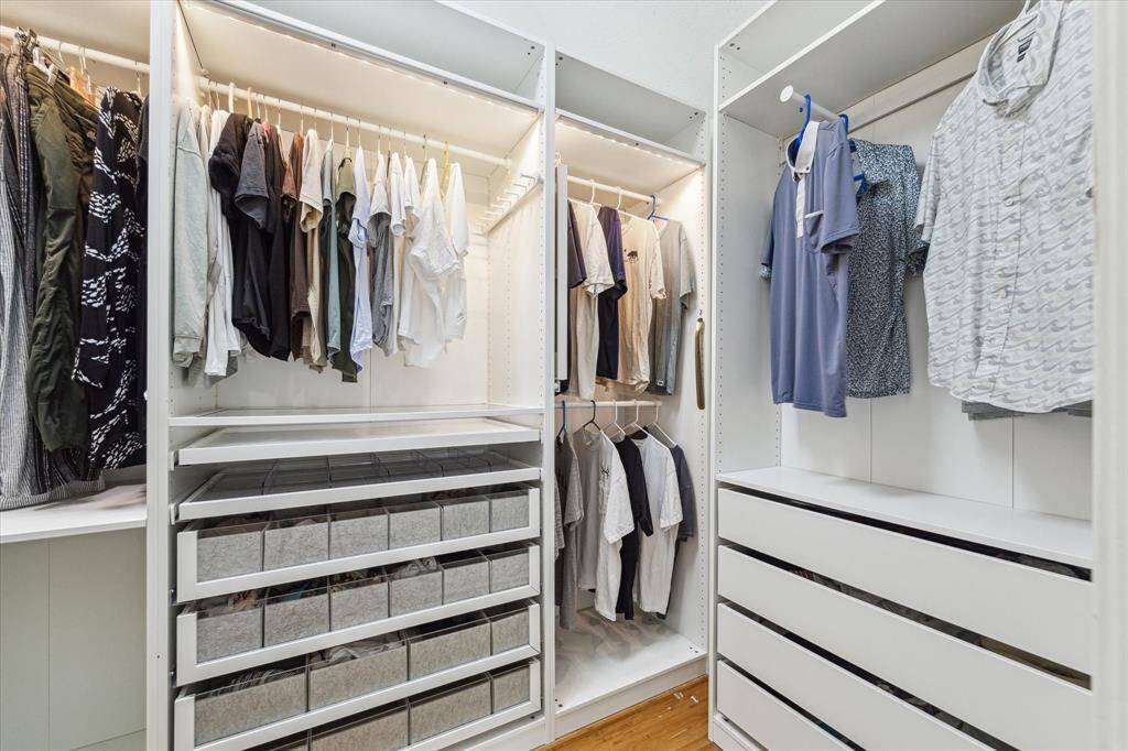 The built-ins provide hanging space, drawers, and separate compartments, making it both visually pleasing and easy to use.
