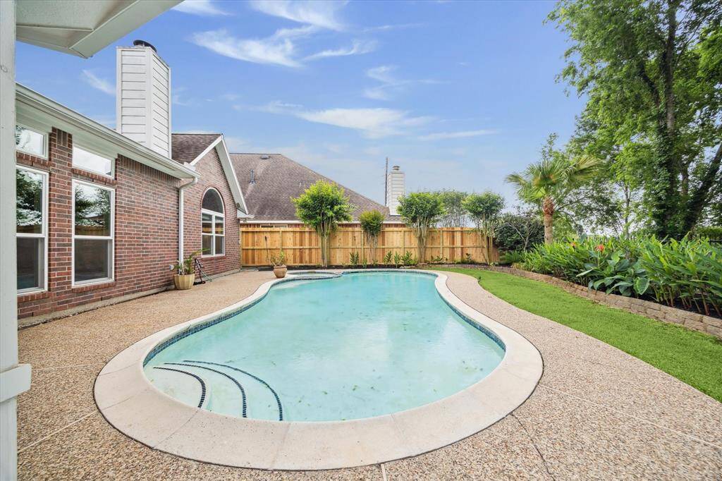 Ample space around the pool's exterior for lounge chairs, with a brand new side fence adding a fresh touch to the property.