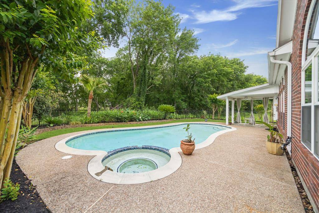 This home showcases a stunning swimming pool, relaxing hot tub, and a spacious covered patio—an ideal setting for ultimate outdoor enjoyment and entertaining.