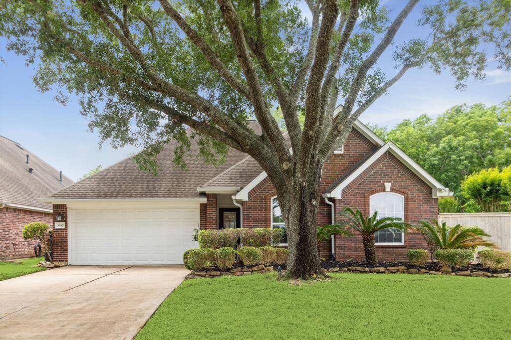Front view of this beautiful brick home, featuring well-maintained landscaping.