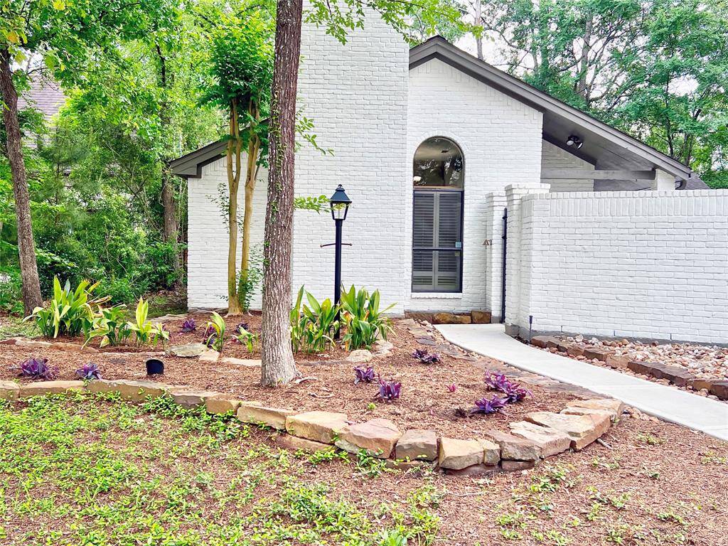 Lovely Grogan's Mill home nestled in trees.