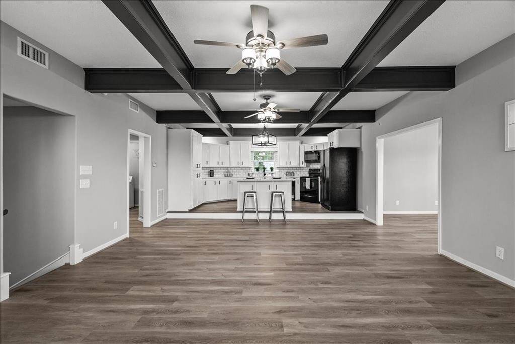 Large wood beams accent the living area