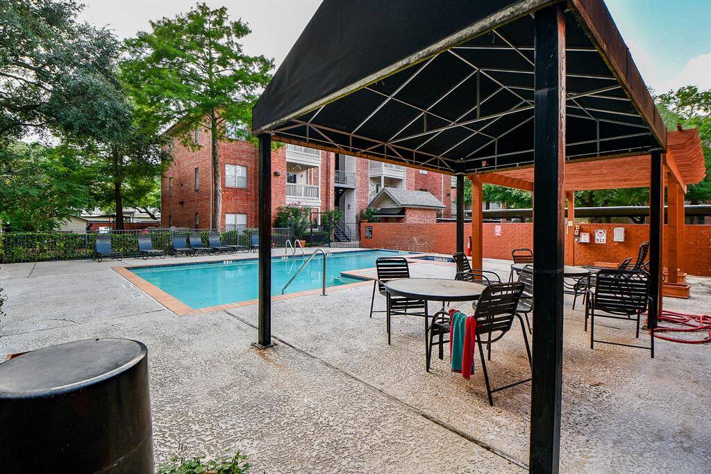 The pool offers a covered area for relaxation or dining.